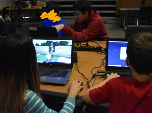 Students and mentor in front of computers